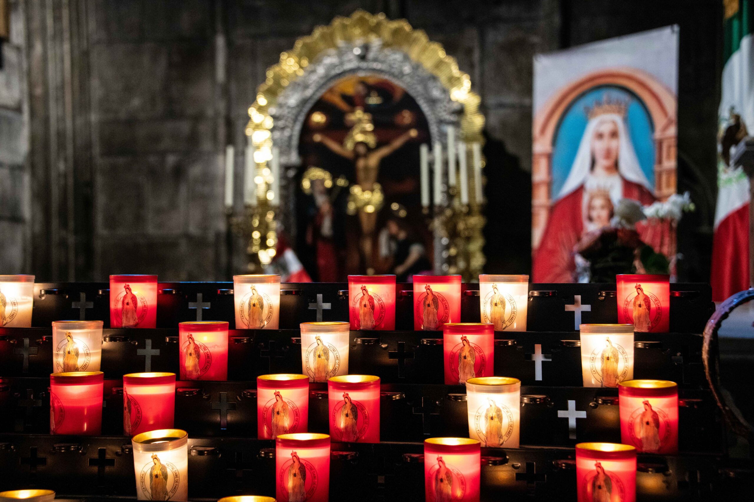 Votive candles lit in prayer